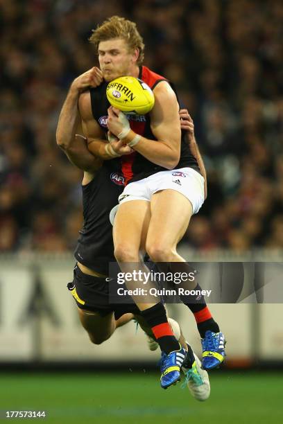 Michael Hurley of the Bombers marks infront of Jarrad Waite of the Blues during the round 22 AFL match between the Carlton Blues and the Essendon...