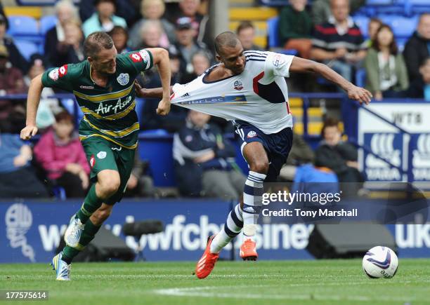 David Ngog of Bolton Wanderers is pulled back by his shirt by Clint Hill of Queens Park Rangers during the Sky Bet Championship match between Bolton...