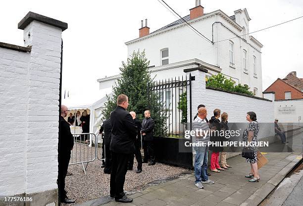 People enter French actor Gerard Depardieu's home in Nechin for a housewarming garden party organized by Depardieu after a ceremony during which he...