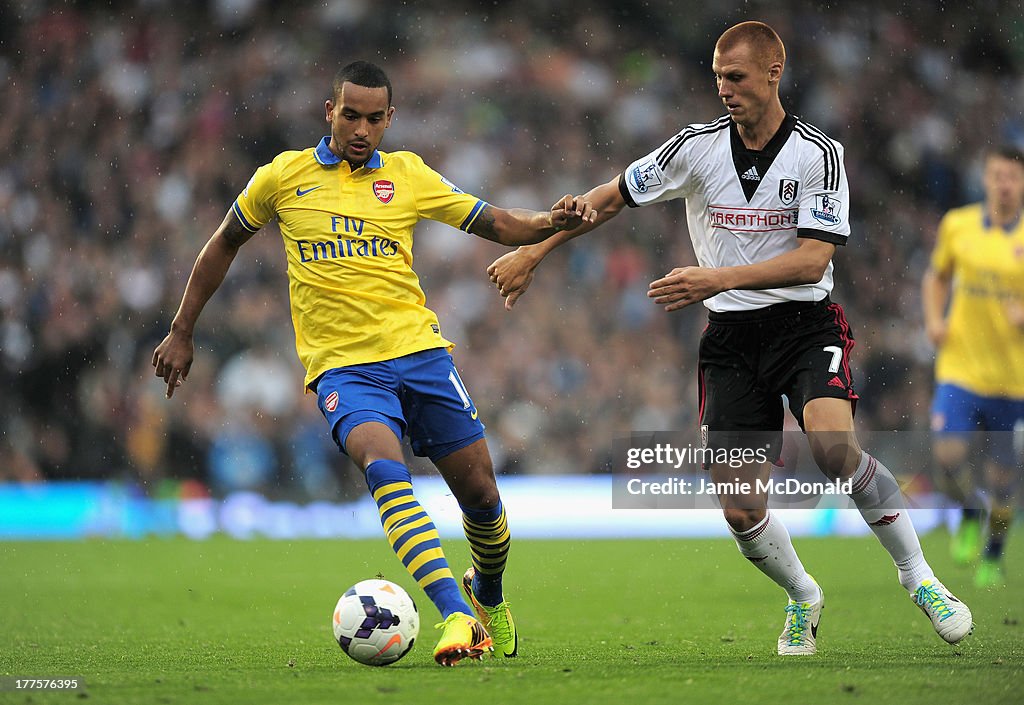 Theo Walcott of Arsenal is closed down by Steve Sidwell of Fulham