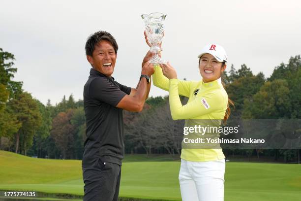 Mone Inami of Japan poses with her caddie after winning the tournament following the final round of the TOTO Japan Classic at the Taiheiyo Club's...