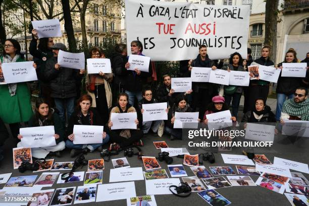 Protestors, holding a banner which reads as "In Gaza, the State of Israel also kills journalists" and displaying the names and photographs of the...