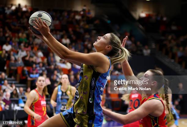 Gemma Potter of the Capitals drives to the basket during the round one WNBL match between UC Capitals and Adelaide Lightning at National Convention...