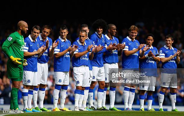 Everton players line up and clap during a minutes applause before the Barclays Premier League match between Everton and West Bromwich Albion at...