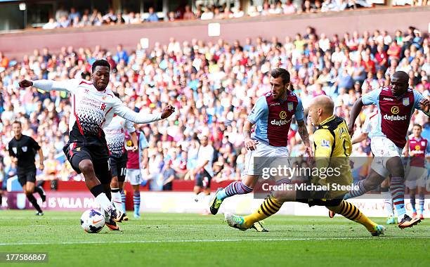 Daniel Sturridge of Liverpool rounds goalkeeper Brad Guzan of Aston Villa to score the opening goal during the Barclays Premier League match between...