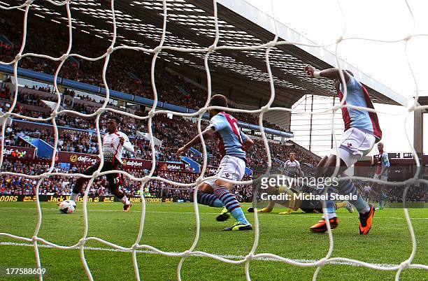 Daniel Sturridge of Liverpool rounds goalkeeper Brad Guzan of Aston Villa to score the opening goal during the Barclays Premier League match between...