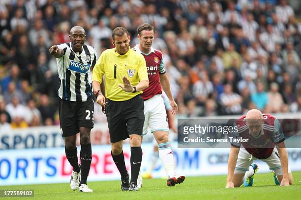 Shola Ameobi of Newcastle argues with referee Phil Dowd during the Barclays Premiership Match between Newcastle United and West Ham United at St....
