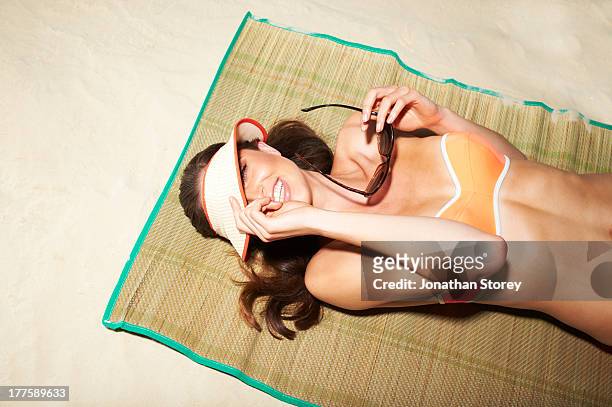 beach coy - sunbathing stockfoto's en -beelden