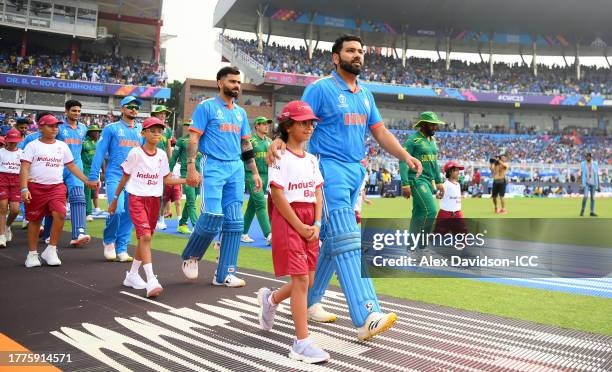 Rohit Sharma of India and Temba Bavuma of South Africa lead their sides out for the National Anthems ahead of the ICC Men's Cricket World Cup India...