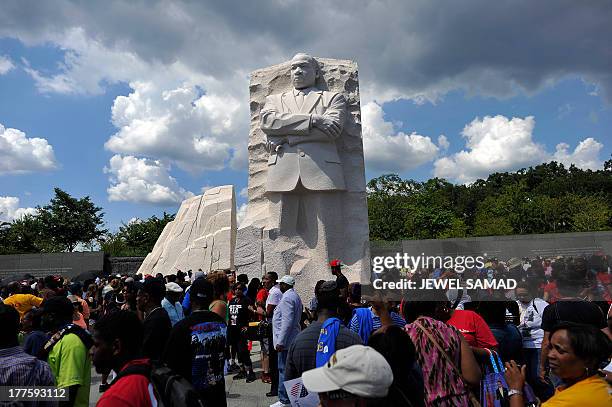 People gather at Martin Luther King Jr. Memorial on August 24 in Washington, DC, to celebrate the 50th anniversary of The March on Washington. Tens...
