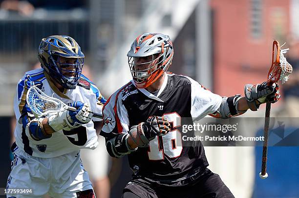 Terry Kimener of the Denver Outlaws battles against Casey Cittadino of the Charlotte Hounds during the 2013 MLL Semifinal game at PPL Park on August...