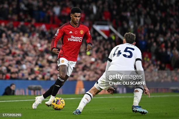 Manchester United's English striker Marcus Rashford fights for the ball with Luton Town's English midfielder Alfie Doughty during the English Premier...