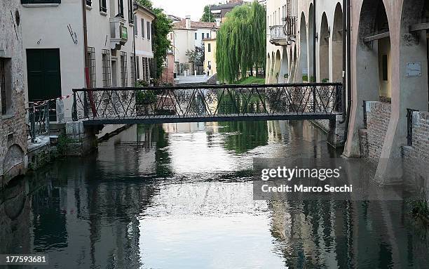 General view of a canal and houses in Treviso seen on August 24, 2013 in Treviso, Italy. Treviso claims that Tiramisu was invented in the 1960s by...