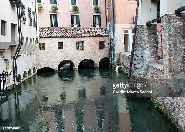 General view of a canal and houses in Treviso seen on August 24, 2013 in Treviso, Italy. Treviso claims that Tiramisu was invented in the 1960s by...