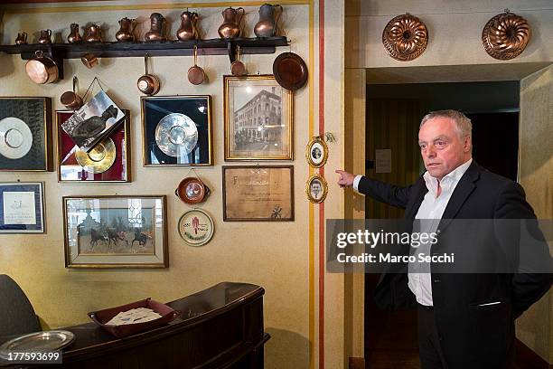 Carlo Campeol the present owner of Restaurant "Alle Beccherie" and son of Alba indicate the photographs of his grandparents who started the...