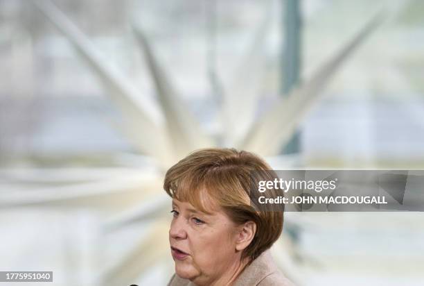 German Chancellor Angela Merkel addresses families and relatives of German police and army personel serving overseas, prior to a yearly Christmas...
