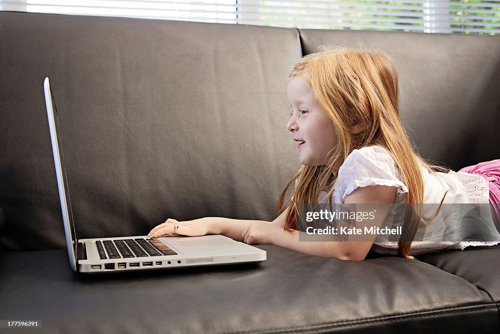 Young girl using laptop to video call