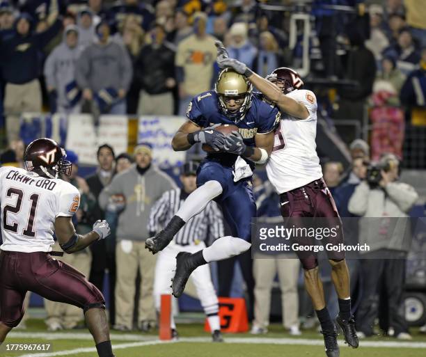Wide receiver Larry Fitzgerald of the University of Pittsburgh Panthers catches a pass as cornerback Vincent Fuller of the Virginia Tech Hokies...