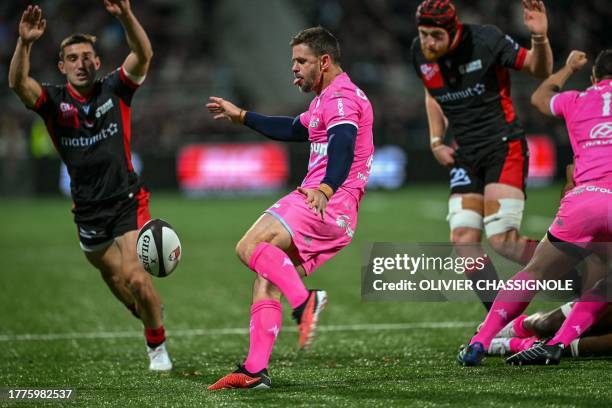 Stade Francais' South African scrum-half Rory Kockott kicks the ball during the French Top14 rugby union match between Lyon Olympique Universitaire...