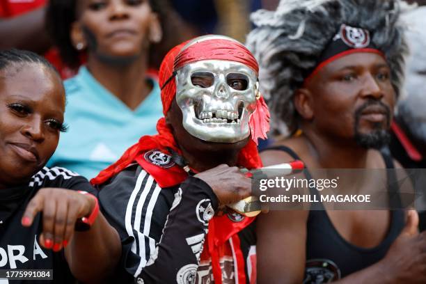 Orlando Pirates supporters cheer during the Premier Soccer League South African Premier Division football match between Kaizer Chiefs and Orlando...