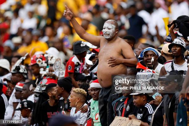 Orlando Pirates supporters cheer during the Premier Soccer League South African Premier Division football match between Kaizer Chiefs and Orlando...