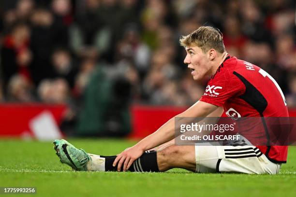 Manchester United's Danish striker Rasmus Hojlund reacts as he is injured during the English Premier League football match between Manchester United...