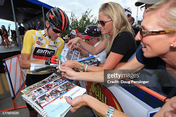 Tejay van Garderen of the USA riding for BMC Racing signs autographs for fans at the start as he went on to defend the overall race leader's yellow...