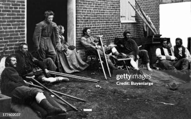 Soldiers outside a brick hospital building in Fredericksburg, Virginia, recovering from wounds received during the battles in the 'Wilderness...