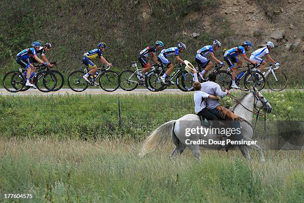 Horseback rider chases the breakaway during stage six of the 2013 USA Pro Challenge from Loveland to Fort Collins on August 24, 2013 in Estes Park,...