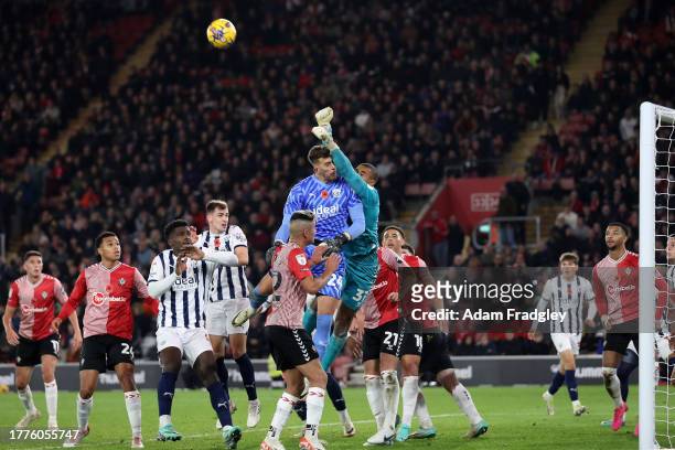 Alex Palmer of West Bromwich Albion is up for a corner in th last minute of added time as Gavin Bazunu of Southampton Football Club punches the ball...