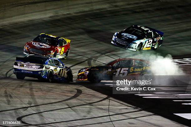Clint Bowyer, driver of the 5-hour ENERGY Toyota, and Bobby Labonte, driver of the Bush's Beans Toyota, are involved in an on-track incident during...