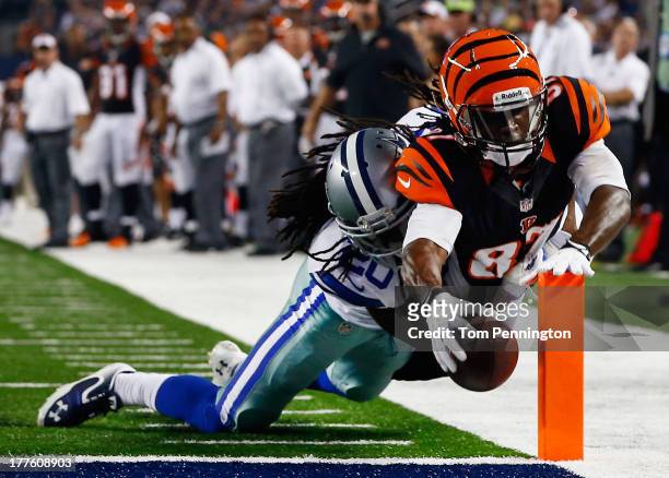 Cobi Hamilton of the Cincinnati Bengals dives into the end zone to score a touchdown against B.W. Webb of the Dallas Cowboys in the fourth quarter...