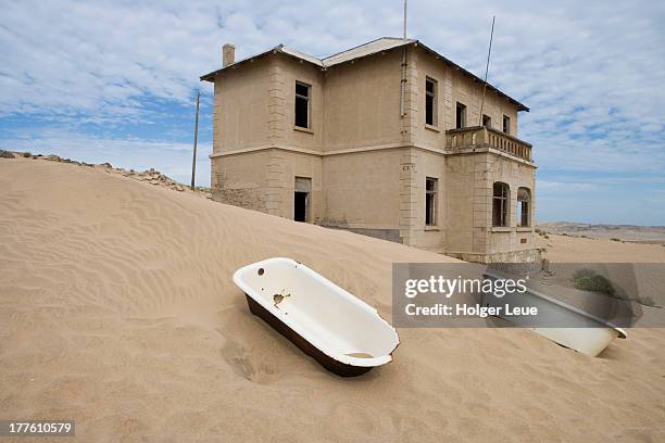 bathtubs in desert and ghost town buildings - kolmanskop namibia stock pictures, royalty-free photos & images