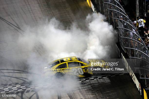 Matt Kenseth, driver of the Dollar General Toyota, celebrates with a burnout after winning the NASCAR Sprint Cup Series 53rd Annual IRWIN Tools Night...