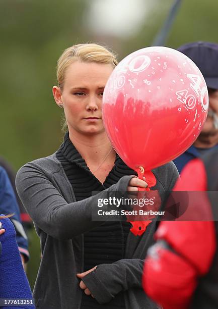 Sarah Harper, the girlfriend of Christopher Lane releases a balloon to celebrate Lane's life during the Chris Lane Memorial Game at the Essendon...