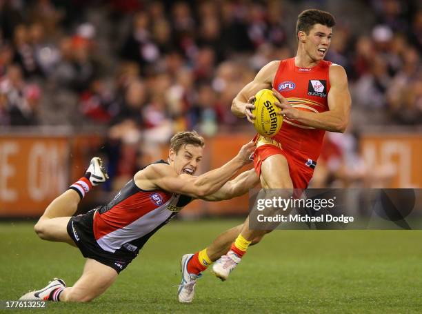 Tom Curren of the Saints tackles Jaeger O'Meara of the Suns during the round 22 AFL match between the St Kilda Saints and the Gold Coast Suns at...