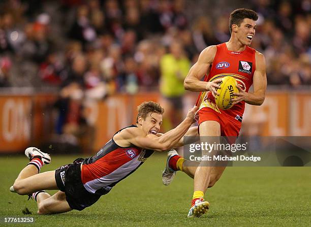 Tom Curren of the Saints tackles Jaeger O'Meara of the Suns during the round 22 AFL match between the St Kilda Saints and the Gold Coast Suns at...