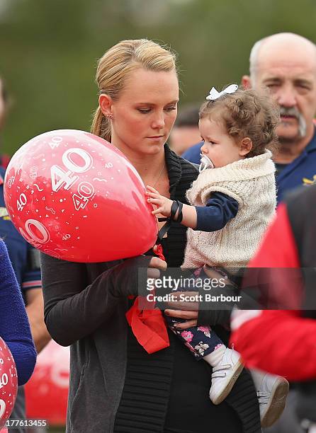 Sarah Harper, the girlfriend of Christopher Lane holds Chris's niece Amelia as she releases a balloon to celebrate Lane's life during the Chris Lane...