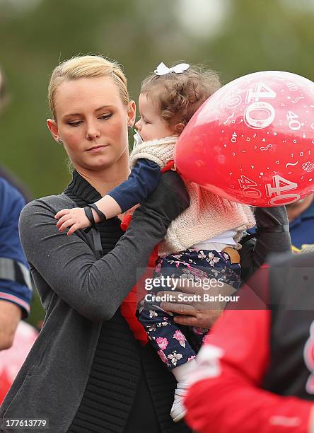 Sarah Harper, the girlfriend of Christopher Lane holds Chris's niece Amelia as she releases a balloon to celebrate Lane's life during the Chris Lane...