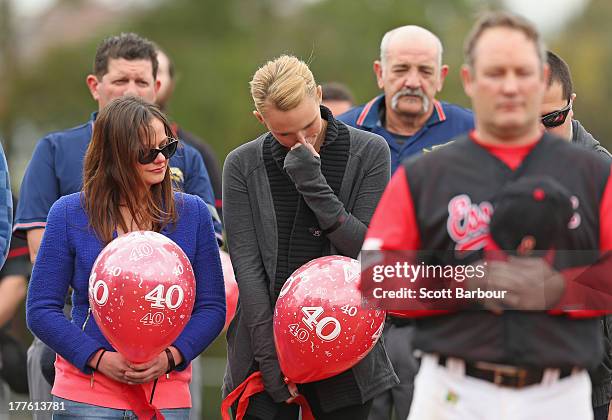 Sarah Harper , the girlfriend of Christopher Lane and Erin Lane, sister of Christopher Lane stand for a minute's silence and the release of balloons...