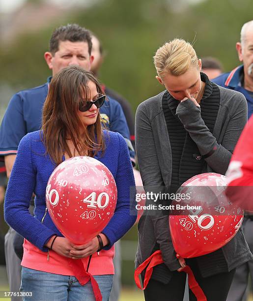 Sarah Harper , the girlfriend of Christopher Lane and Erin Lane, sister of Christopher Lane stand for a minute's silence and the release of balloons...