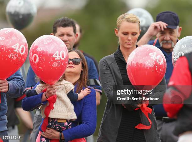 Sarah Harper , the girlfriend of Christopher Lane and Erin Lane, sister of Christopher Lane holding her daughter Amelia release balloons to celebrate...