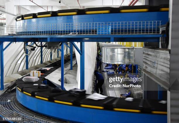 Workers sort express deliveries at a ZTO Express transfer center in Handan, Hebei province, China, Nov 10, 2023.