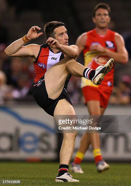 Stephen Milne of the Saints kicks the ball during the round 22 AFL match between the St Kilda Saints and the Gold Coast Suns at Etihad Stadium on...