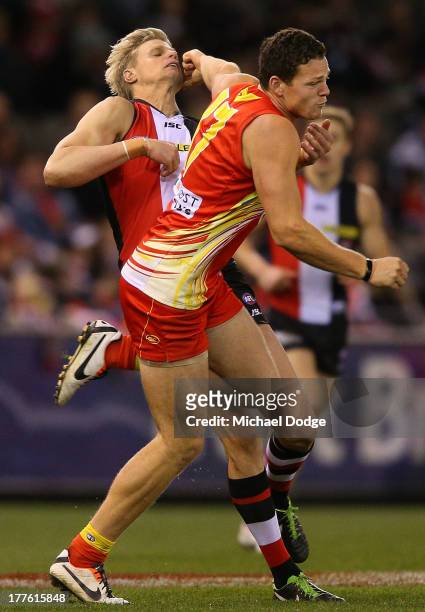 Nick Riewoldt of the Saints gets hit behind play by Steven May of the Suns contest for the ball during the round 22 AFL match between the St Kilda...