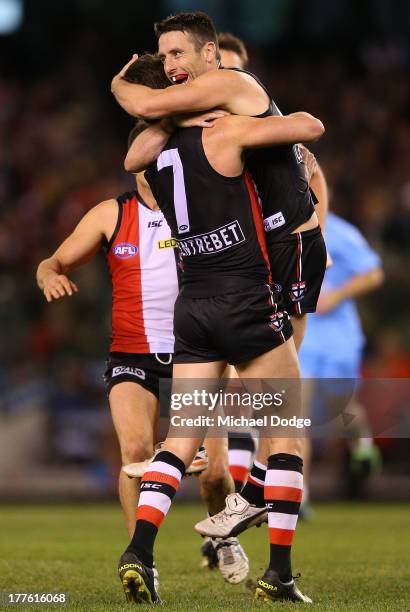 Stephen Milne and Lenny Hayes of the Saints celebrate a goal during the round 22 AFL match between the St Kilda Saints and the Gold Coast Suns at...