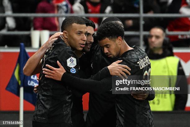 Paris Saint-Germain's French forward Kylian Mbappe celebrates with Paris Saint-Germain's French midfielder Warren Zaire-Emery and teammates after...