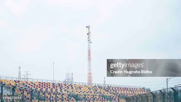 scenery of sport tribune with open blue sky and telecomunication tower - tribune tower stock pictures, royalty-free photos & images