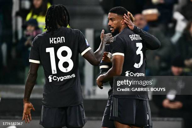 Juventus' Brazilian defender Bremer is congratulated by teammates Juventus' Italian forward Moise Kean and Juventus' US midfielder Weston McKennie...