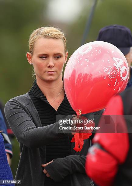 Sarah Harper, the girlfriend of Christopher Lane releases a balloon to celebrate Lane's life during the Chris Lane Memorial Game at the Essendon...